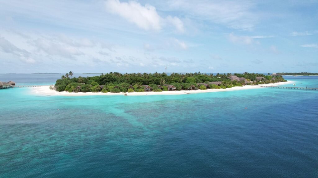 Tropical island resort in maldives with turquoise water and white sand beaches