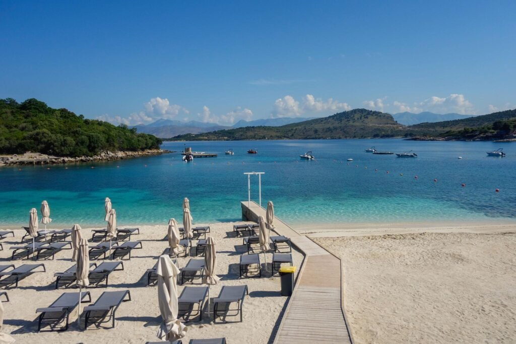 beach umbrellas closed during low season on the beach in Ksamil, Albanian rivieira.