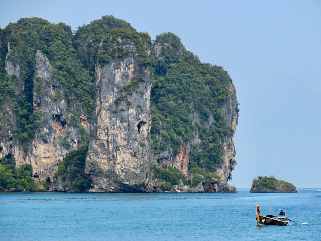 A Boat and Spectacular Limestone Cliffs in Krabi, Thailand