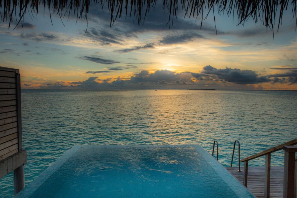 Sunset view of an infinity pool on the edge of the ocean