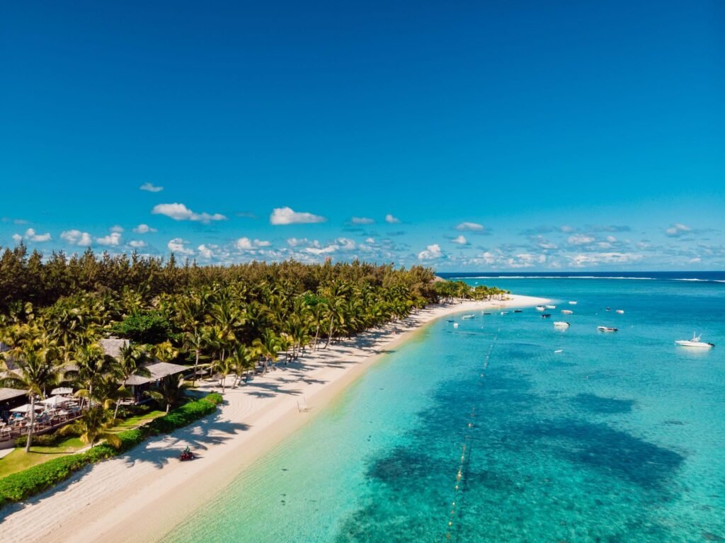 Luxury beach with resort and blue ocean in Mauritius. Aerial view