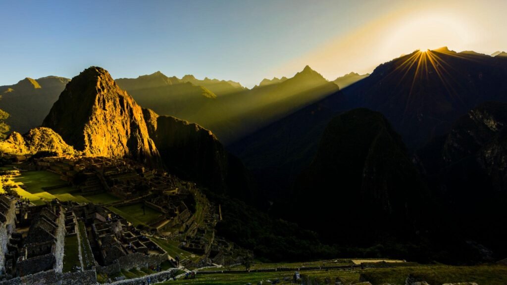 Sun rising over the mountains at Machu Picchu, Peru