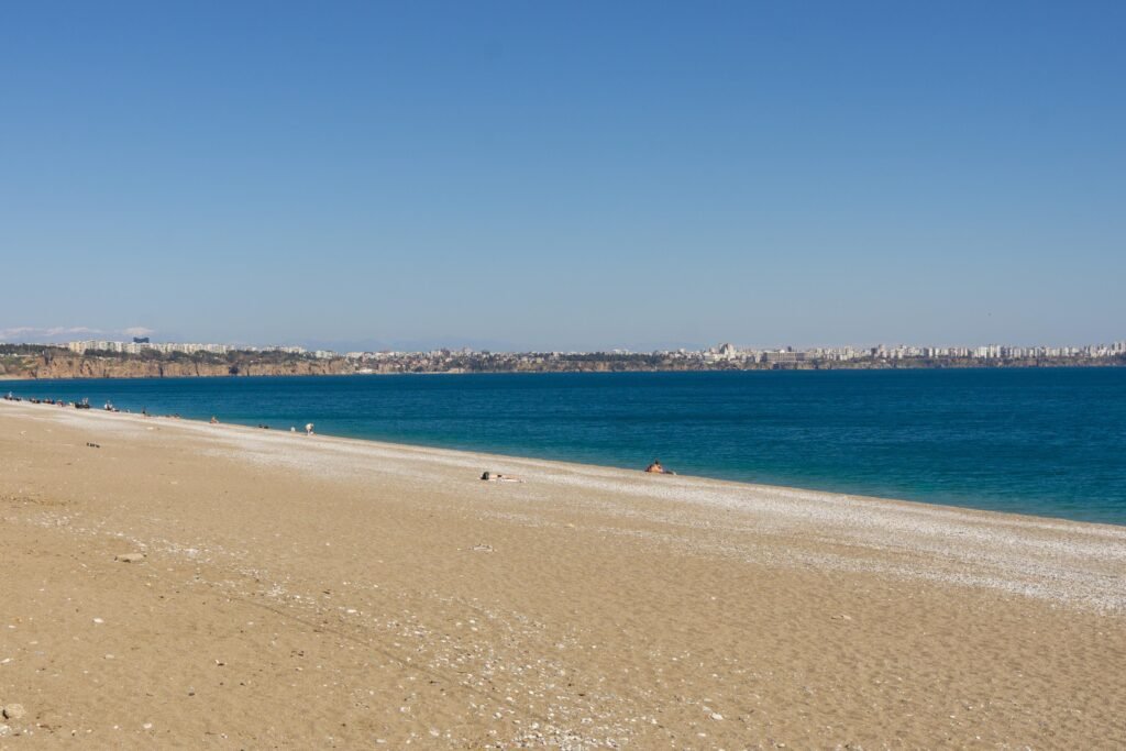 Quiet empty beach and calm turquoise sea during off-season.