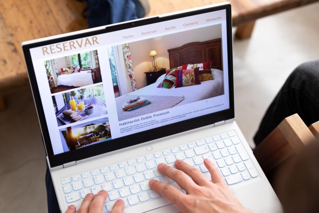 Unrecognizable person reviewing hotels online, using laptop