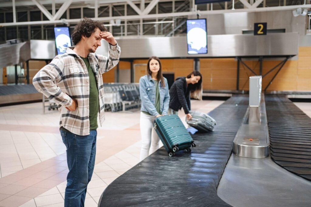 Stressed tourist waiting for lost luggage at the airport