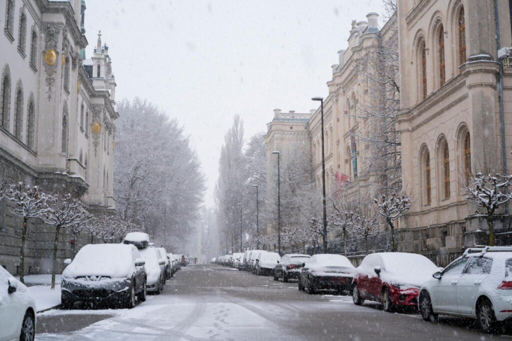 Snowing on empty street with lot of cars on New Years and covid-19 time
