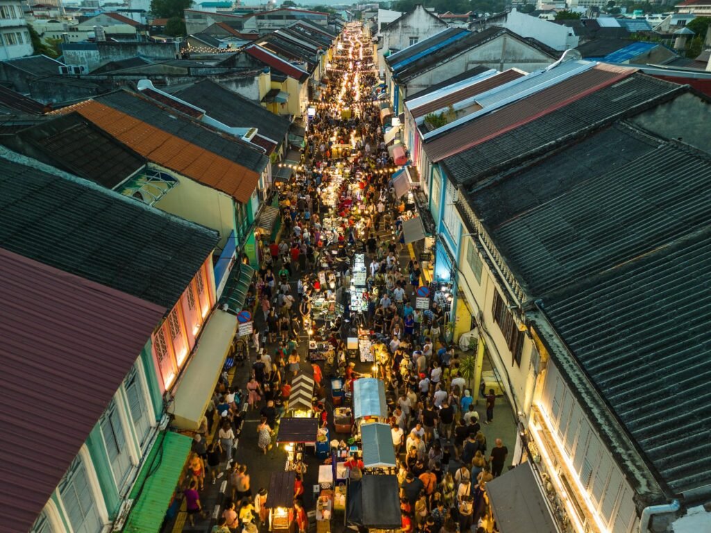 Aerial view Many tourists walk the illuminated walking street in Old Phuket Town at night.