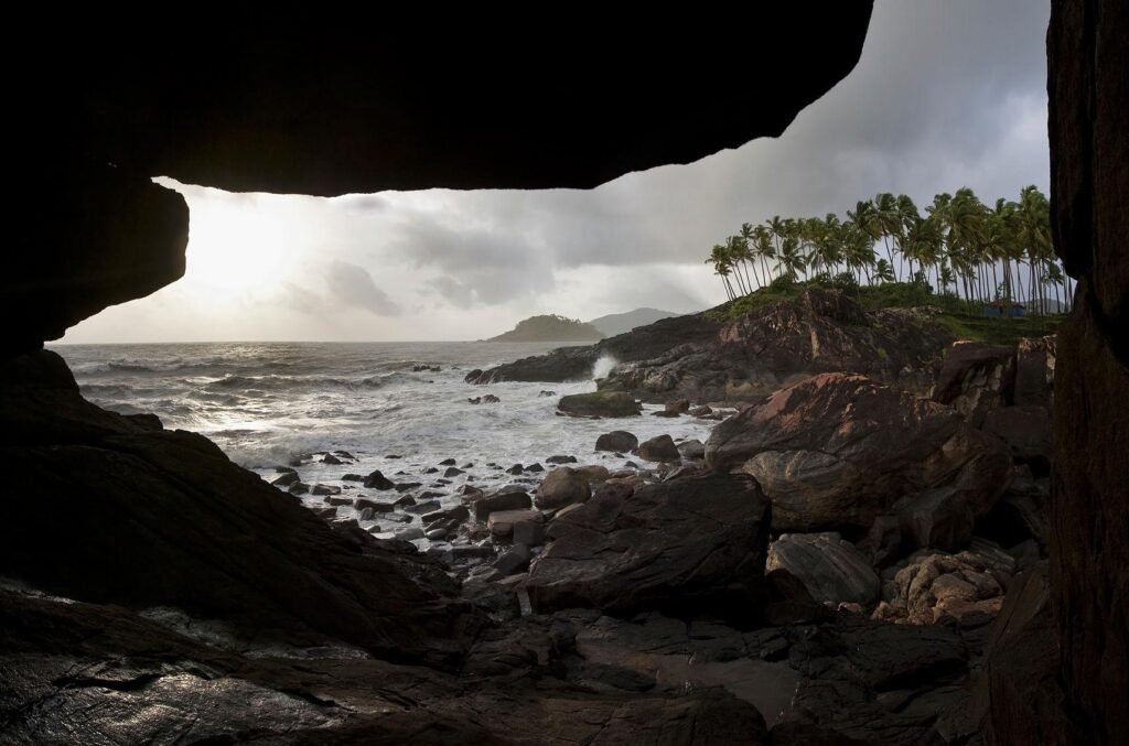 Cave at rocky coastline in Goa