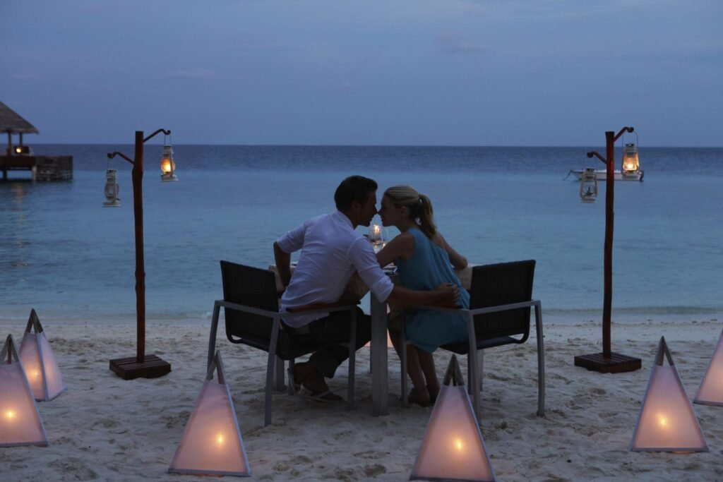 Couple Enjoying Late Meal In Outdoor Restaurant