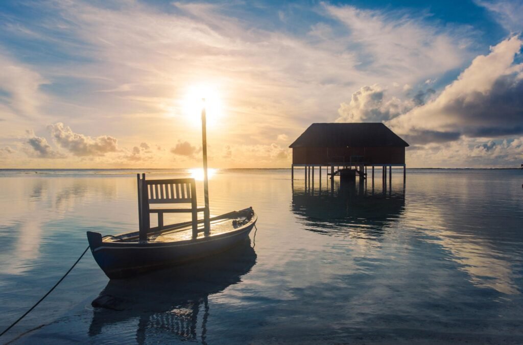 Sunset on Maldives island, romantic honeymoon water villas resort and love boat, Maldives island