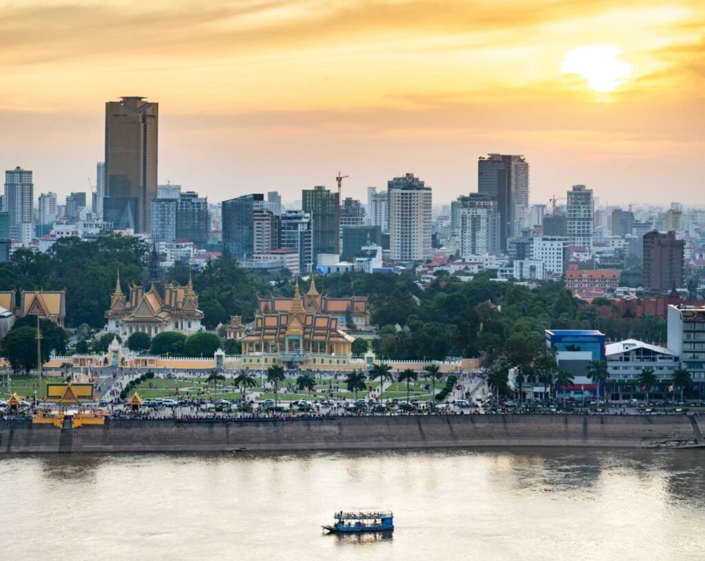 Phnom Penh river cruise boat passing the Royal Palace,at sunset,Cambodia.