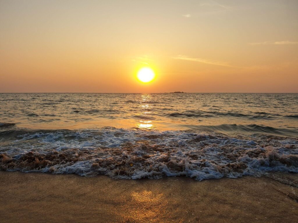 Beautiful view of Sunset or Sunrise during golden hours, at a coastal beach with clear visible horizon. The color of sky is magical due to dispersion of light.