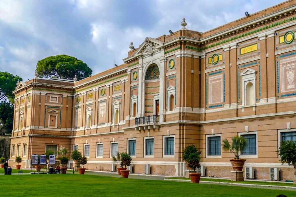Stunning historic building with lush gardens in Vatican City, showcasing classic architecture and intricate details.