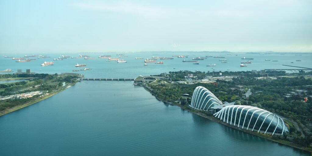 Stunning aerial shot of Singapore's Marina Bay with iconic architecture and ocean harbor.