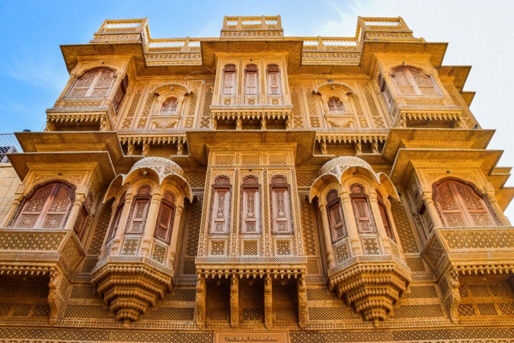 Intricate traditional Indian haveli facade captured under bright sunlight, showcasing ornate architecture.
