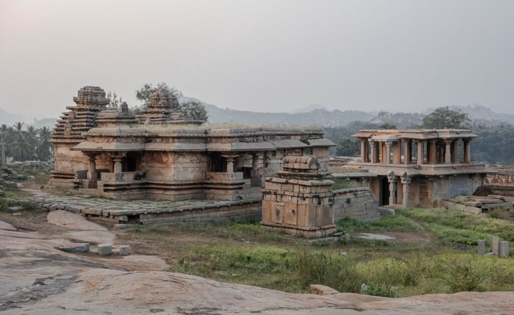 Explore the historic architecture and serene landscape of Hampi in Karnataka, India, at dusk.