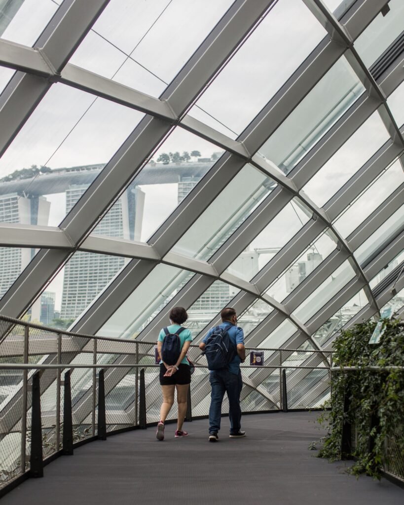 Tourists walking in Singapore, with Marina Bay Sands visible. A modern architectural marvel.