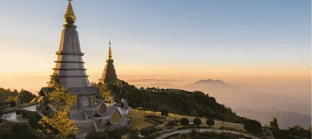 Twin pagodas at Doi Inthanon National Park overlooking misty mountains during sunrise in Chiang Mai, Thailand
