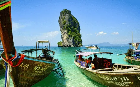 Traditional Thai long-tail boats near Koh Poda Island with crystal-clear turquoise water in Krabi, Thailand