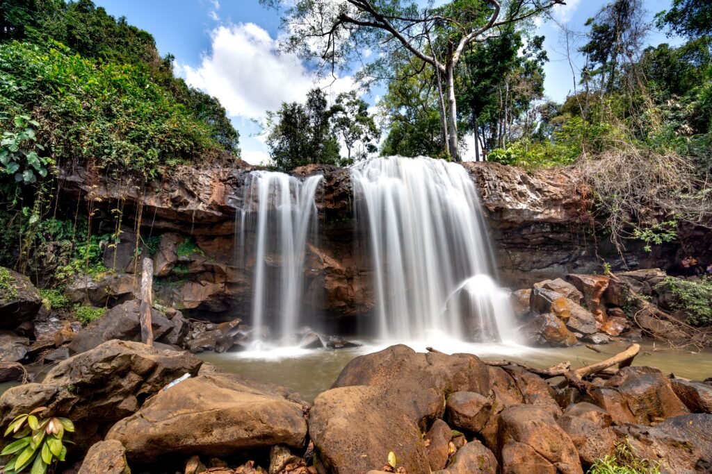 Captivating waterfall flowing through a lush green forest, showcasing nature's beauty and tranquility.