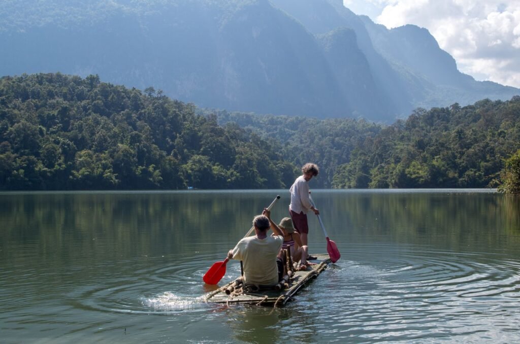 Explore bamboo rafting in Chiang Dao surrounded by lush greenery and mountain views.