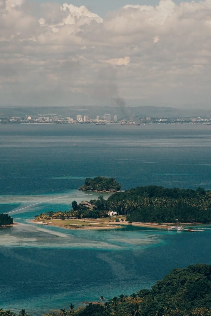 Stunning aerial view of the Samal Island coastline, highlighting lush nature and sparkling waters.