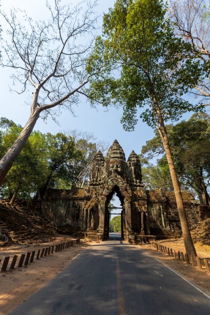 Majestic ancient entrance gate surrounded by trees at Angkor Wat, Cambodia.