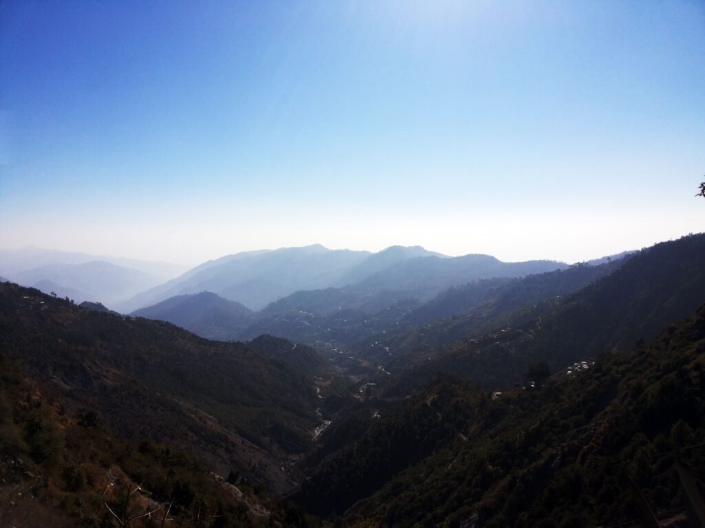 Stunning landscape of a mountain range with clear blue skies, perfect for nature enthusiasts.