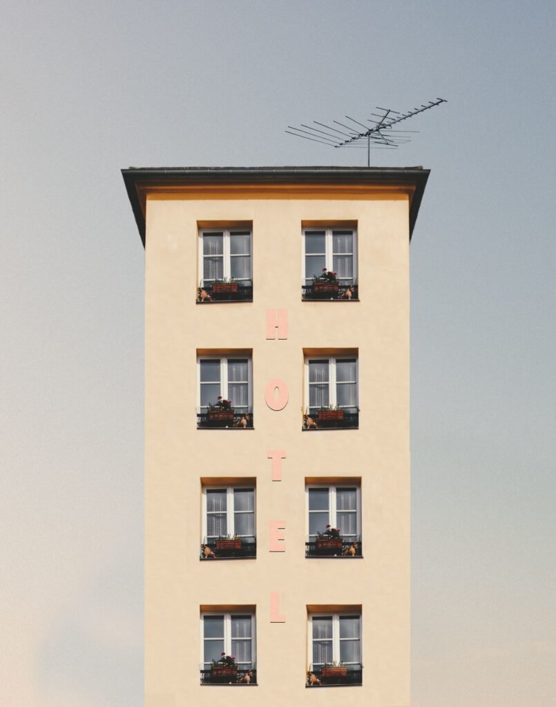 A minimalist hotel facade showcasing clean lines, symmetry, and bright daylight.