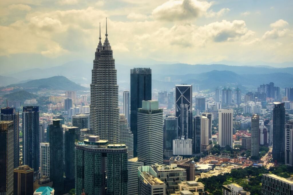 A stunning aerial view of Kuala Lumpur's skyline highlighting the iconic Petronas Towers.