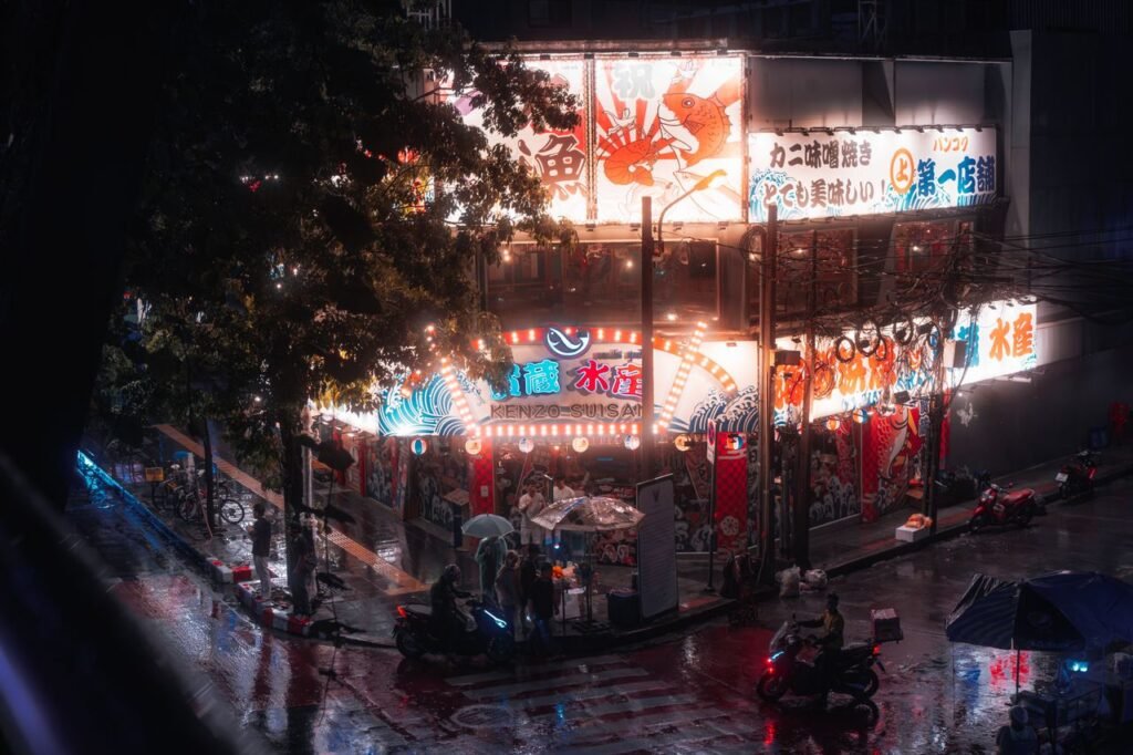 Neon-lit street corner capturing vibrant nightlife in Bangkok, Thailand.