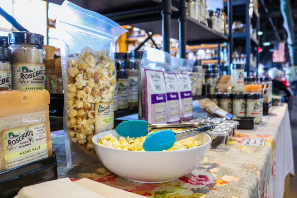 Organic popcorn and seasoning display at an Ohio farmers market showcasing local food products.