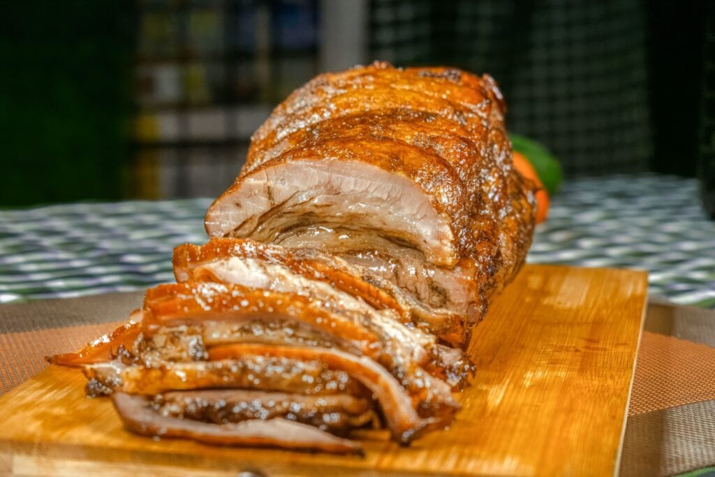 Deliciously roasted beef slices displayed on a rustic wooden board, perfect for a gourmet meal.