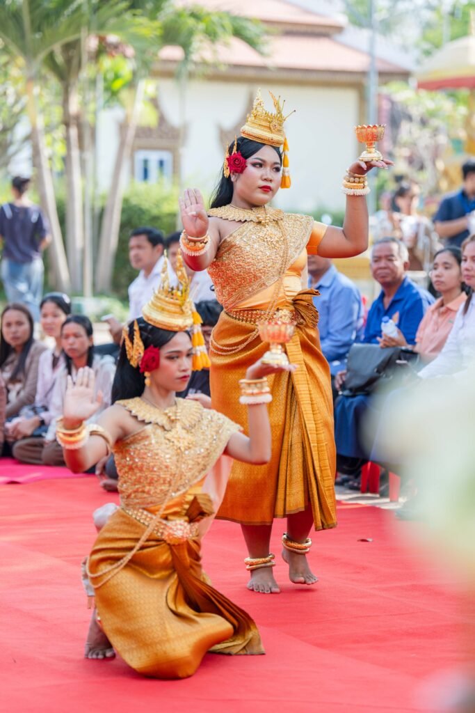 Colorful Khmer dancers in traditional attire performing at a public event in Battambang, Cambodia.