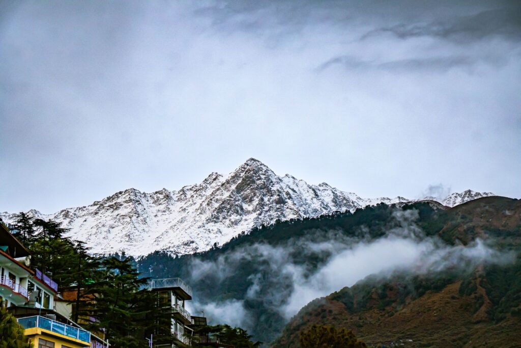 Scenic view of snow-capped mountains with clouds in Dharamshala, HP, India.