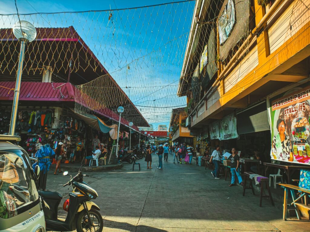 Explore the bustling street market in Dumaguete City with colorful stalls and lively atmosphere.