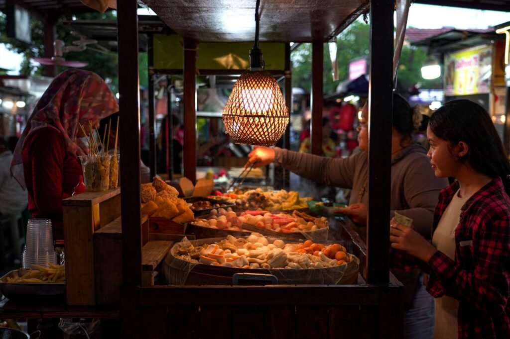 A vibrant street food market scene captured in Denpasar, Bali, showcasing traditional market activities.