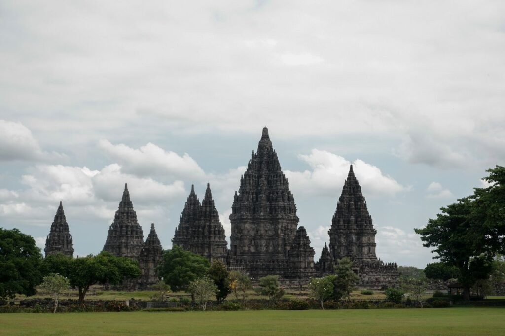 Stunning view of the Prambanan Temple complex under a cloudy sky in Indonesia.
