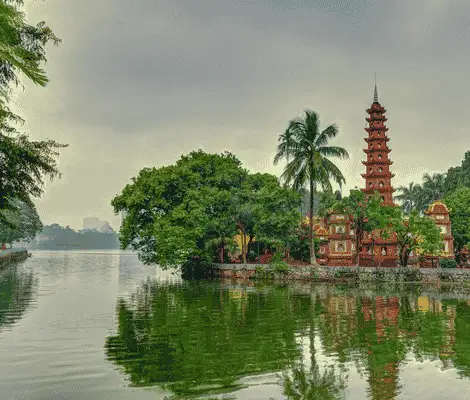 Tran Quoc Pagoda beside West Lake in Hanoi, Vietnam, reflected in calm water