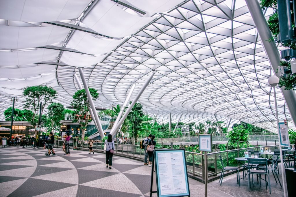 A stunning blend of modern architecture and lush greenery in an indoor airport garden.