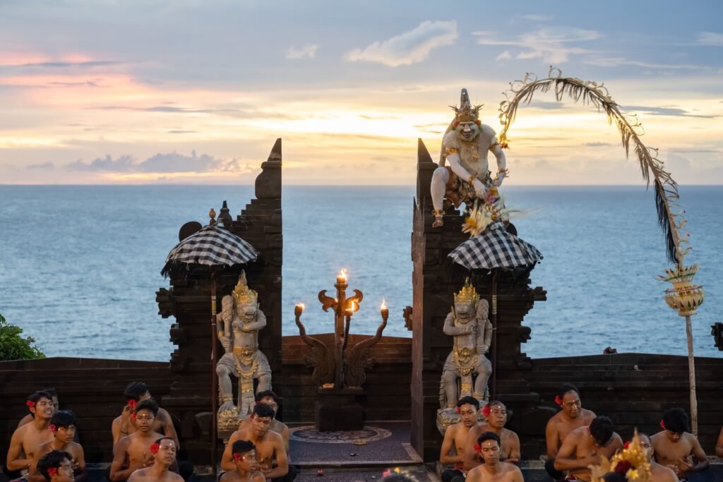 Vibrant Kecak dance performance at Uluwatu Temple, Bali, against a stunning sunset.