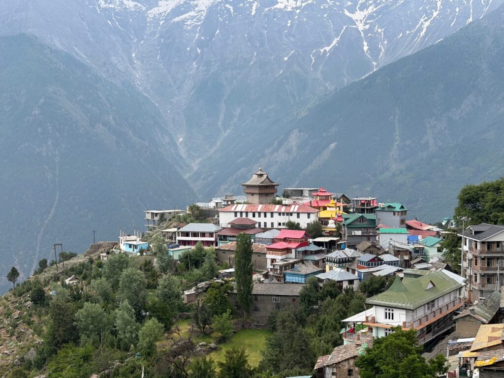 Charming village of Kalpa nestled in the majestic Himalayas under a bright day sky.